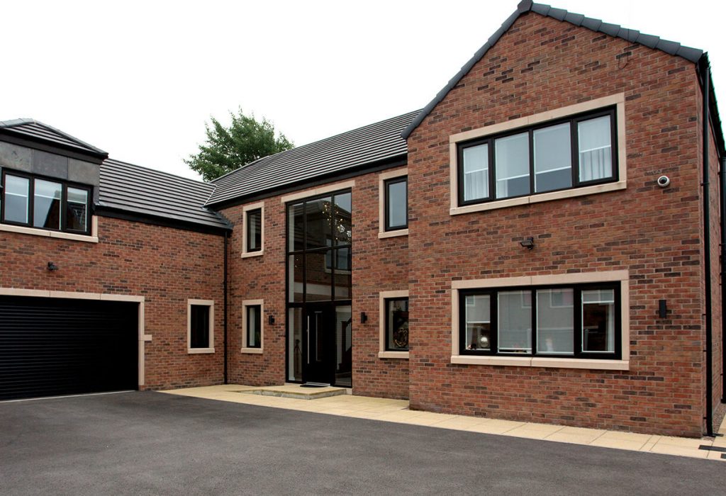 Black aluminium casement windows on a red bricked house